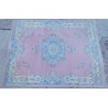 A large Indian carpet, decorated with flowers, on a pink ground, approx 270cm wide.