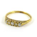 An 18ct gold diamond set Victorian gypsy ring, set with five old cut diamonds, each in claw setting,