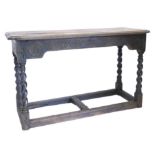 An oak side table, the rectangular top with re-entrant corners and a moulded edge, above a frieze