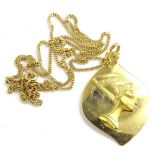 An Egyptian pendant and chain, the leaf design pendant set with Egyptian head, yellow metal, the