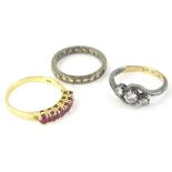 Three dress rings, comprising a ruby set half hoop eternity ring, yellow metal stamped 14K, with