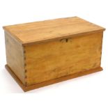 A reclaimed pine small chest, the hinged lid enclosing a vacant interior, on a plinth, 62.5cm wide.