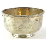 A George V silver bowl, with a moulded edge and tapering foot, London 1933, 6oz, 12cm diameter.