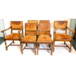 A set of six oak dining chairs, each with a brown leather padded back and seat, on part turned legs,