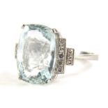 An aquamarine and diamond dress ring, set with central aquamarine 14.4mm x 10.6mm x 7.8mm, totalling