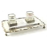 A George V silver presentation ink stand, of rectangular form with a shaped edge and two glass