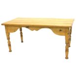 A pine coffee table, the rectangular four planked top above a shaped frieze on turned legs,