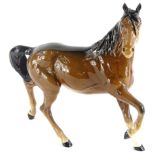 A Royal Doulton trotting horse, right leg raised, head right, printed marks beneath, 22cm high.