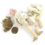 A Simon & Halbig bisque headed doll, the reverse stamped 909, 0 Germany, with composition limbs etc.