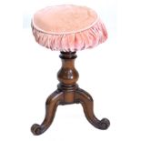 A Victorian mahogany adjustable piano stool, with a circular padded top and baluster turned column