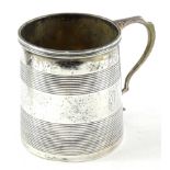 An Edward VII silver cylindrical christening mug, with reeded decoration and shaped handle, inset to