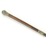 A brown leather riding crop, with gilt white metal mounts cast and embossed with flowers, etc.,