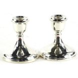 A pair of Elizabeth II silver dwarf candlesticks, each with loaded bases, Birmingham 1982, 11cm