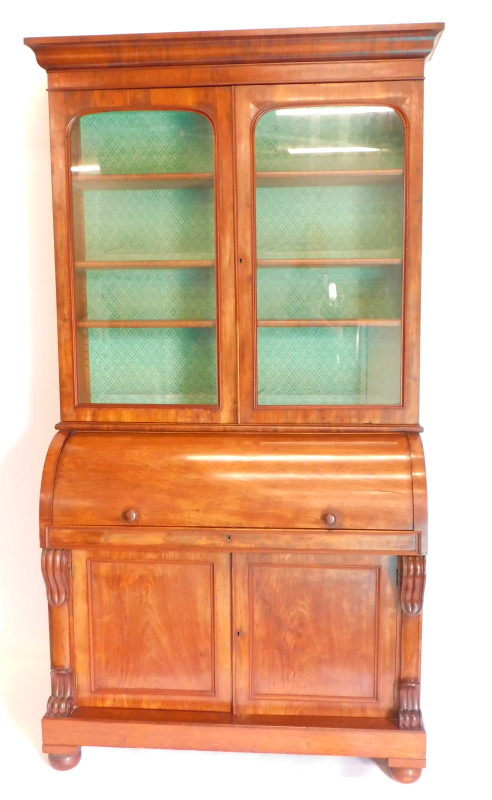 A Victorian mahogany cylinder bureau bookcase, the top with a moulded cornice with two glazed doors,