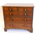 An early 19thC mahogany chest, of two short and three long graduated drawers, with knob handles