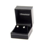 A pair of 18ct white gold diamond stud earrings, each round brilliant cut diamond in a four claw