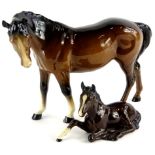 A Beswick horse, brown colourway, head right, standing, 17cm high and a recumbent foal, 915, marks