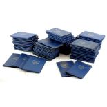 A large quantity of Britain's First Decimal coin sets, each in a blue plastic folder.