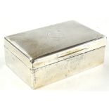 A George V silver rectangular cigarette box, the hinged lid with engine turned decoration and
