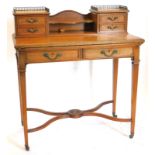 An Edwardian mahogany writing table, the raised back with two brass pierced galleries, two pairs