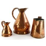 A 19thC copper flagon (AF), 29cm high, a small flagon and another similar (3).