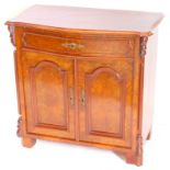 A 19thC continental burr walnut side cabinet, the serpentine top with a moulded edge above a