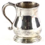 A George V baluster shaped mug, engraved with a laurel wreath and with shaped handle, inscribed to