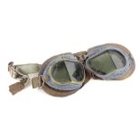 A pair of flying goggles, grey painted onto a brass, with leather coated padding, glass (AF).