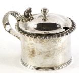 A George IV silver cylindrical mustard pot, with a gadrooned border, leaf cast handle, the hinged
