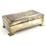 A George V silver cigarette box, the hinged shaped lid with engine turned decoration and with