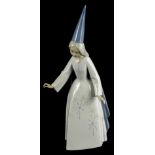 A Lladro porcelain figure of a young witch, numbered to underside 5495, 27cm high (boxed).