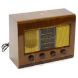 A Bush vintage radio, in a walnut case with four Bakelite knobs, 50cm wide.