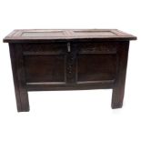 A late 17th/early 18thC oak coffer, with a panelled top, with a carved frieze, with double