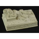 A 19thC French clay sculpture, modelled in the form of a reclining Huntsman with a dog, tablet