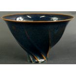 Chris Carter (b1945). A studio ceramic deep bowl, with wrythen shape, glazed in blue and mottled