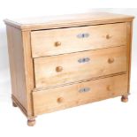 A 19thC continental stripped pine chest of drawers, the top with a moulded edge above three long
