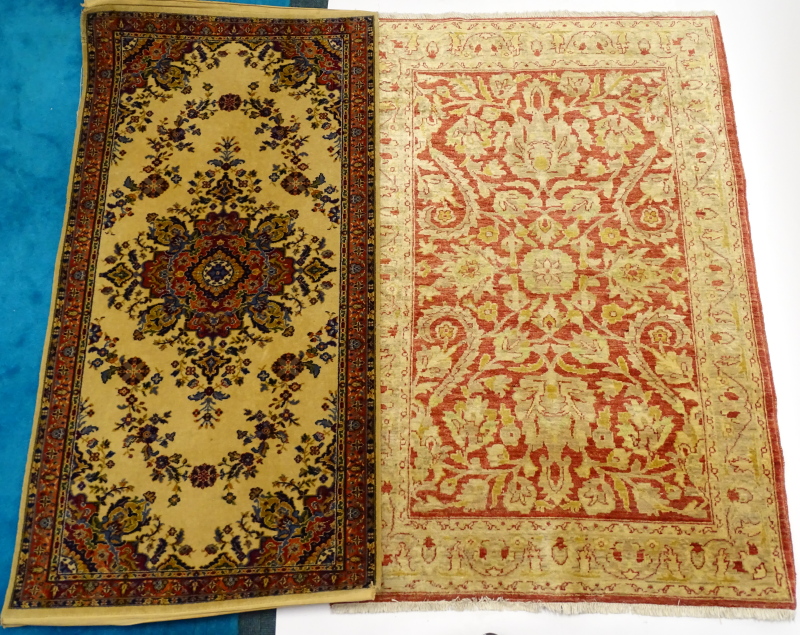 A modern Ziegler rug, with an all over design of flowers, leaves, etc., in cream on a red ground,