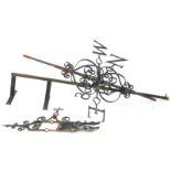 A wrought iron weather vane, the top mounted with a stylised flag and pointer, 163cm high. By family