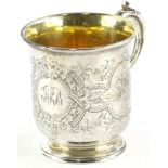 A mid Victorian silver christening mug, engraved overall with scrolls, flowers, etc. and with