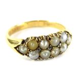 A pearl and diamond set gypsy ring, set with ten cultured pearls of varying colour, from cream to