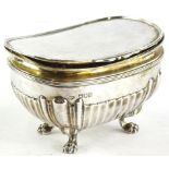 An Edward VII silver boat shaped sugar box, the hinged lid enclosing a vacant interior, the base