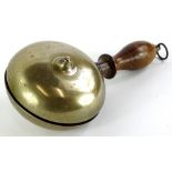 A brass and turned wooden muffin shaped hand bell, possibly American, 28cm long.