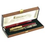 Two red and gold Parker fountain pens, and other fountain pen and a Papermate case.