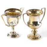 A George V small silver two handled trophy cup, with flowerhead cast edge and angular handles,