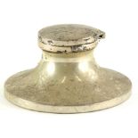 A George V silver Capstan inkwell, with a hinged lid, the circular base engraved with initials J.