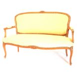 A early 20thC French style beech sofa, with a moulded frame, with flowers, with padded back arm