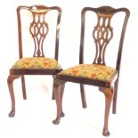 A pair of early 20thC mahogany dining chairs in George III style, each with a pierced splat, a