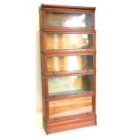 An early 20thC oak Globe Wernicke five section bookcase, with typical hinged glazed doors, the lower