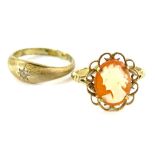 Two dress rings, comprising a 9ct gold cameo set dress ring, with wirework floral design frame, 2.4g