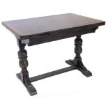 An oak draw leaf dining table, with a rectangular top on turned end supports, with low flat